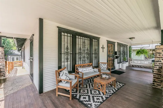 a living room with furniture floor to ceiling window and wooden floor