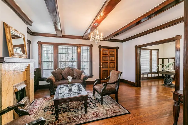 a living room with fireplace furniture and a floor to ceiling window