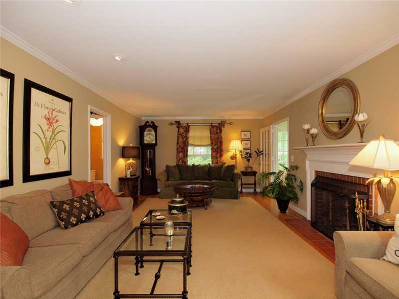 6 By Road Darien, CT 06820 - Photo 6 of 19 a living room with furniture a fireplace and a flat screen tv