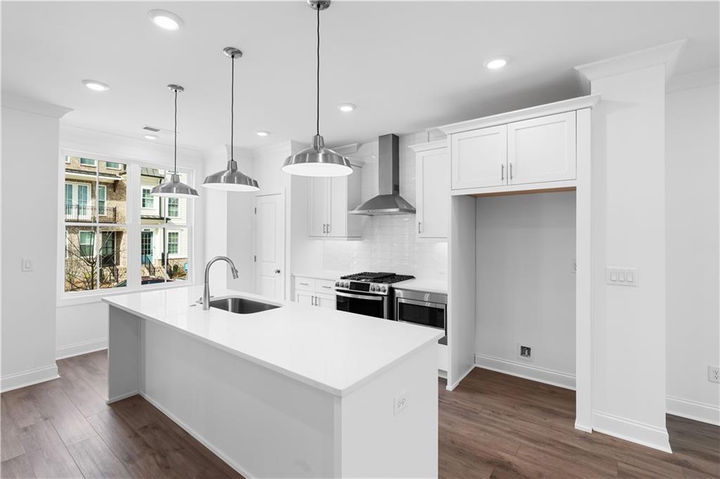 3117 Moor View Road, Unit 36 Duluth, GA 30096 - Photo 1 of 1 a kitchen with stainless steel appliances and wooden floor