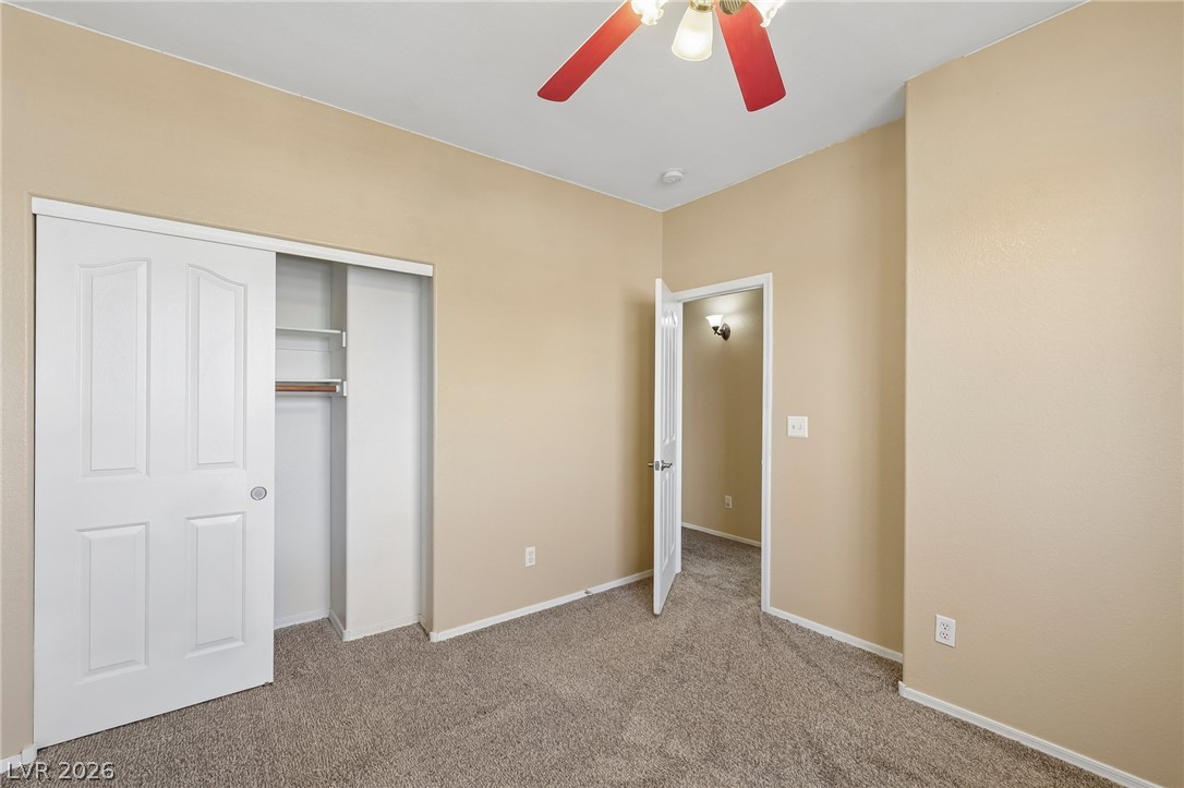 1727 Millstream Way Henderson, NV 89074 - Photo 34 of 46 A well-kept bedroom features a ceiling fan, plush carpeting, and ample closet space for storage.
