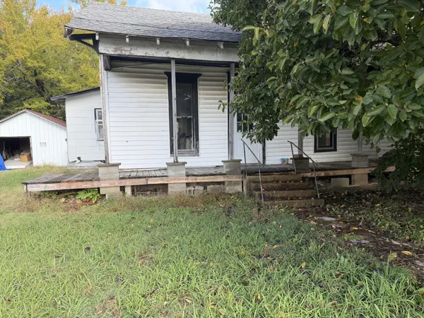 a backyard of a house with wooden floor and fence