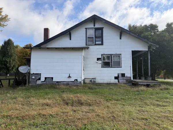 a house that has a big yard and a large tree