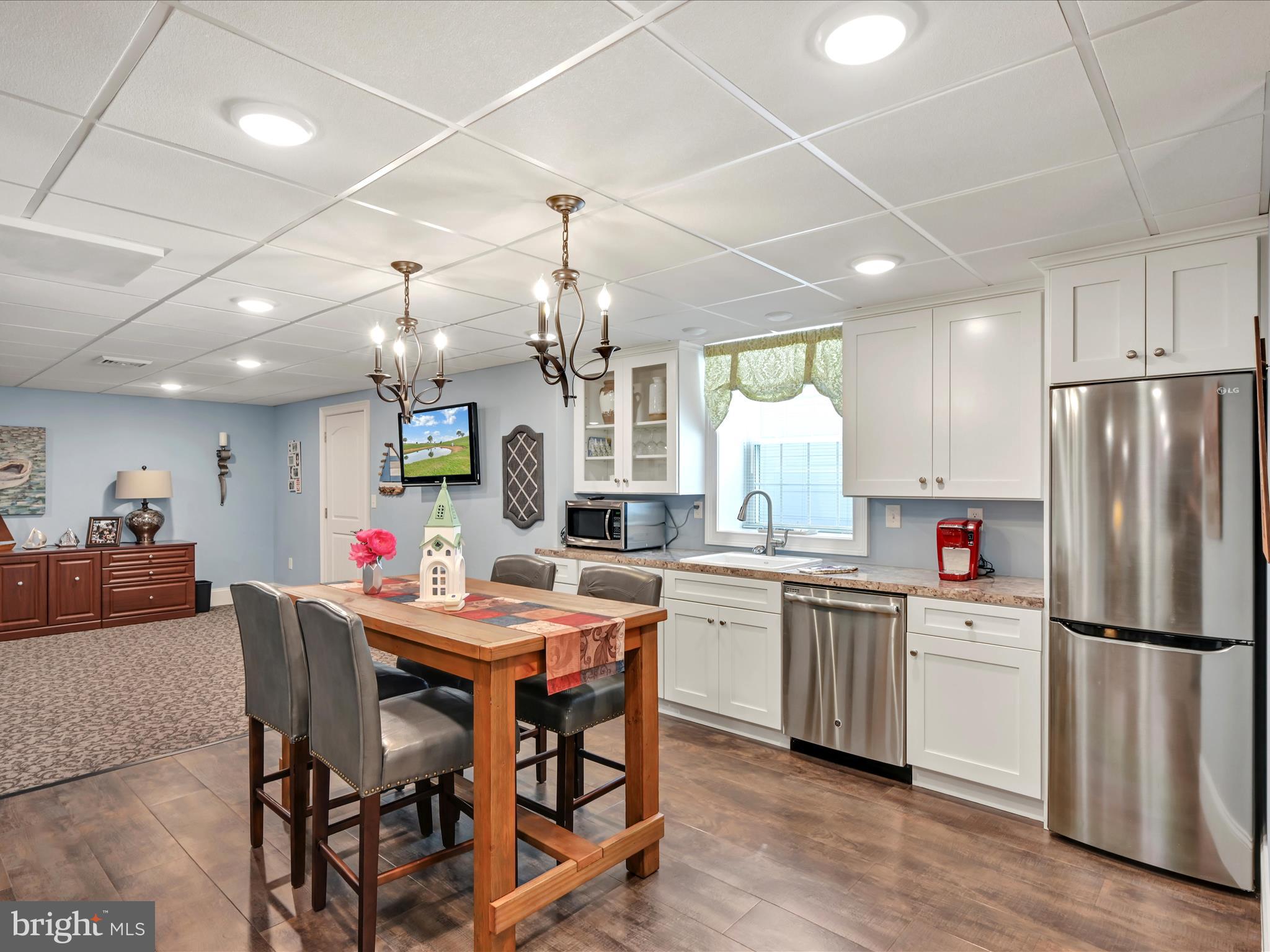 992 Buckwalter Road Lititz, PA 17543 - Photo 48 of 62 a kitchen with stainless steel appliances kitchen island granite countertop a dining table chairs and white cabinets