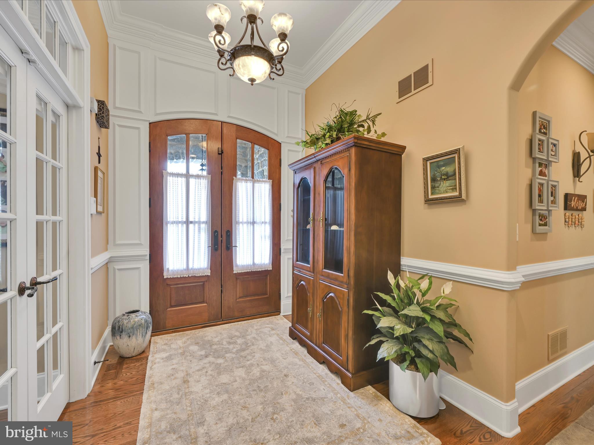992 Buckwalter Road Lititz, PA 17543 - Photo 8 of 62 a view of a hallway with wooden floor and chandelier
