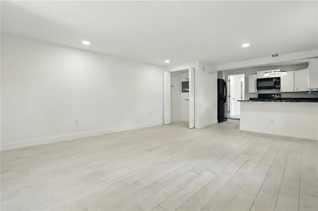a view of a kitchen with a sink and a refrigerator