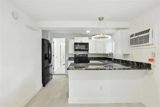 a kitchen with stainless steel appliances granite countertop a sink refrigerator and microwave