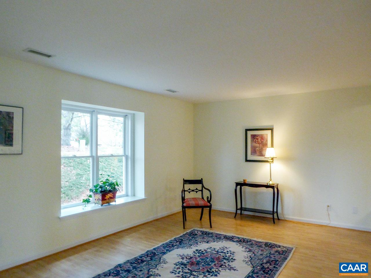 1064 Amber Ridge Road Charlottesville, VA 22901 - Photo 3 of 20 a view of an empty room with a window and wooden floor