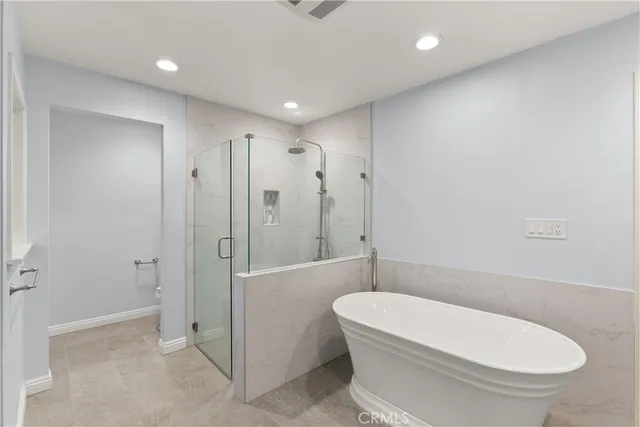 a bathroom with a toilet and shower