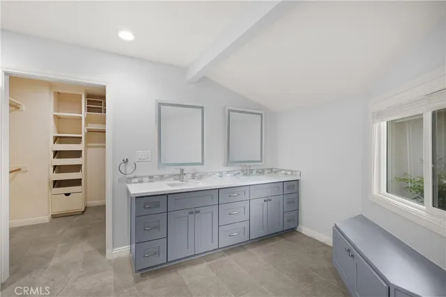 a spacious bathroom with a granite countertop sink a mirror and a bathtub