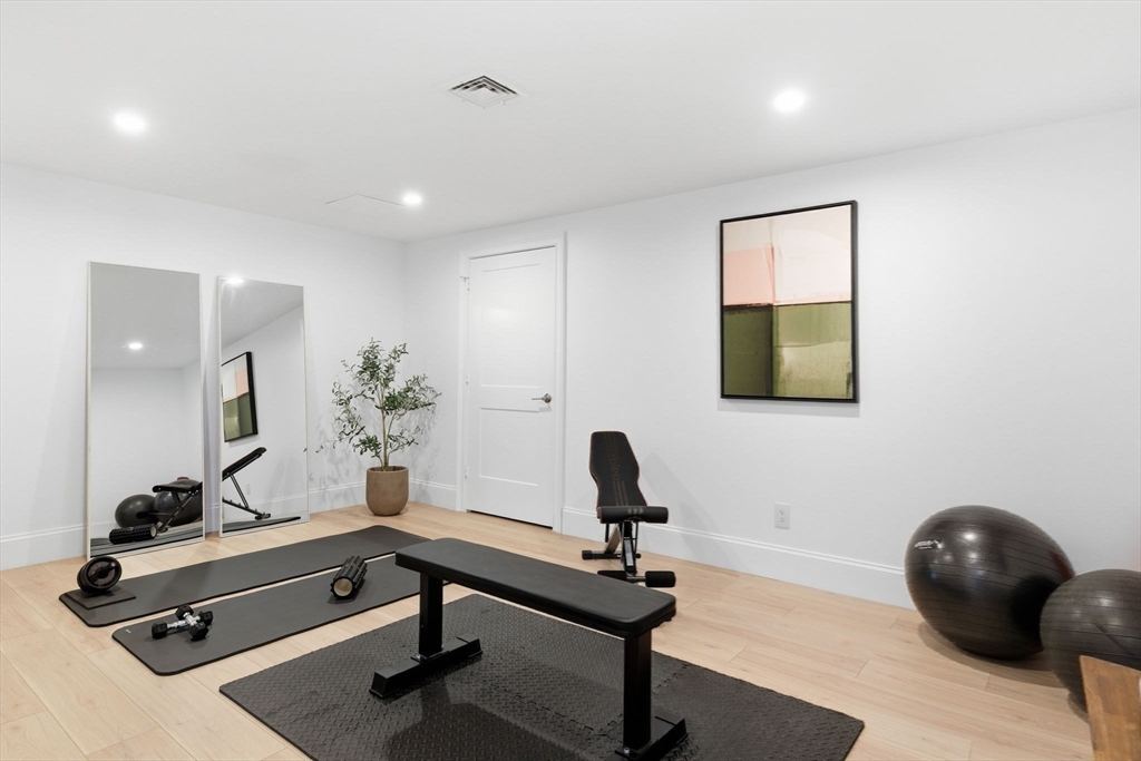 40 Foxcroft Road Winchester, MA 01890 - Photo 40 of 42 a living room with a table and a potted plant