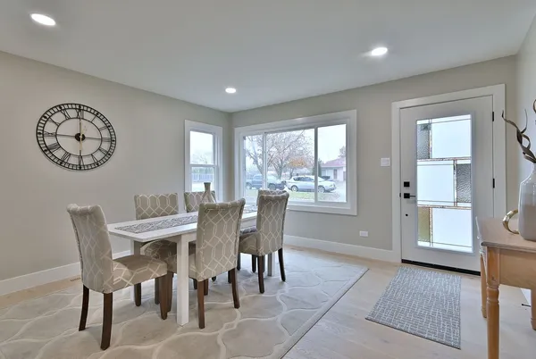 a view of a dining room with furniture and a large window