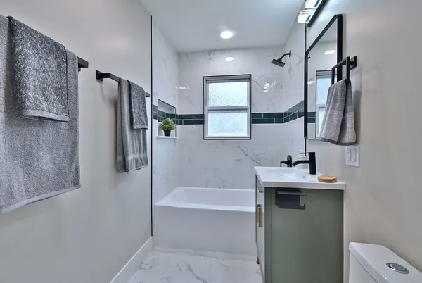 a bathroom with a sink a toilet and bathtub