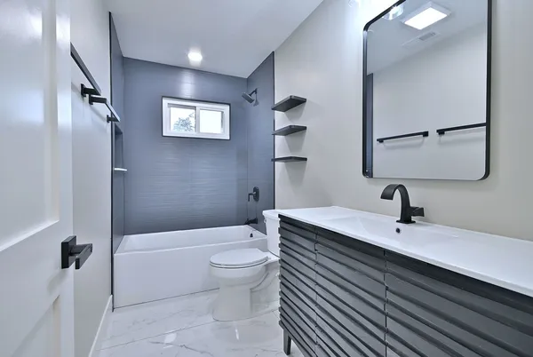 a view of an empty room with a window and closet area