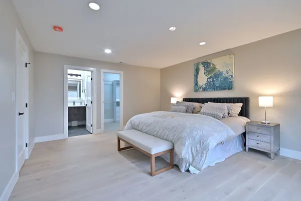 a spacious bedroom with a bed and a window