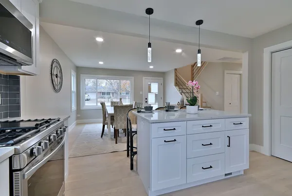 a kitchen with a table chairs and a stove
