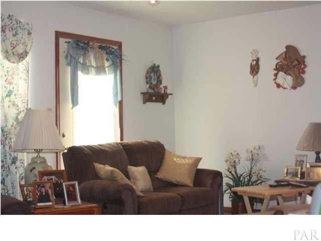380 McKenzie Road Cantonment, FL 32533 - Photo 14 of 18 a living room with furniture and a window
