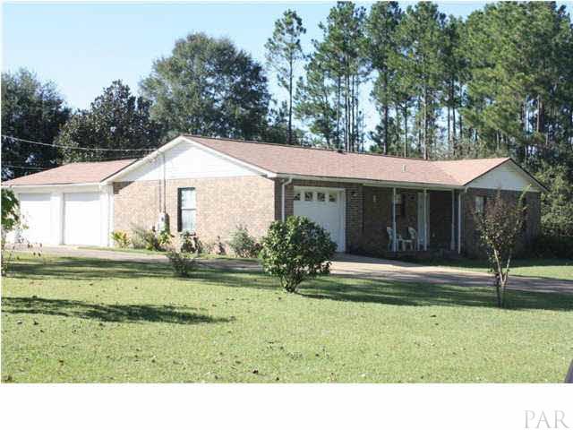 380 McKenzie Road Cantonment, FL 32533 - Photo 2 of 18 a house with a big yard and large trees