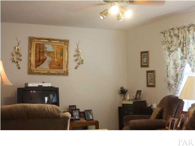 380 McKenzie Road Cantonment, FL 32533 - Photo 10 of 18 a living room with furniture and wall painting