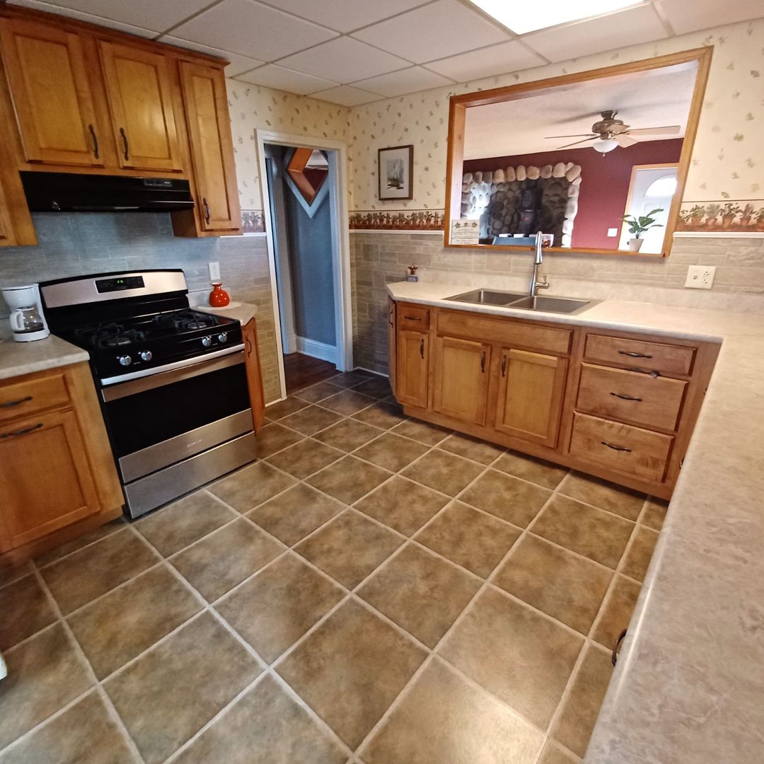 701 East 9th Street Kewanee, IL 61443 - Photo 17 of 56 a kitchen with stainless steel appliances a stove a sink and a microwave
