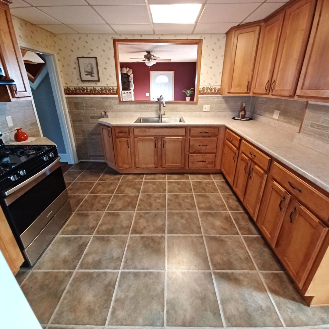 701 East 9th Street Kewanee, IL 61443 - Photo 18 of 56 a kitchen with a sink a stove a microwave and cabinets