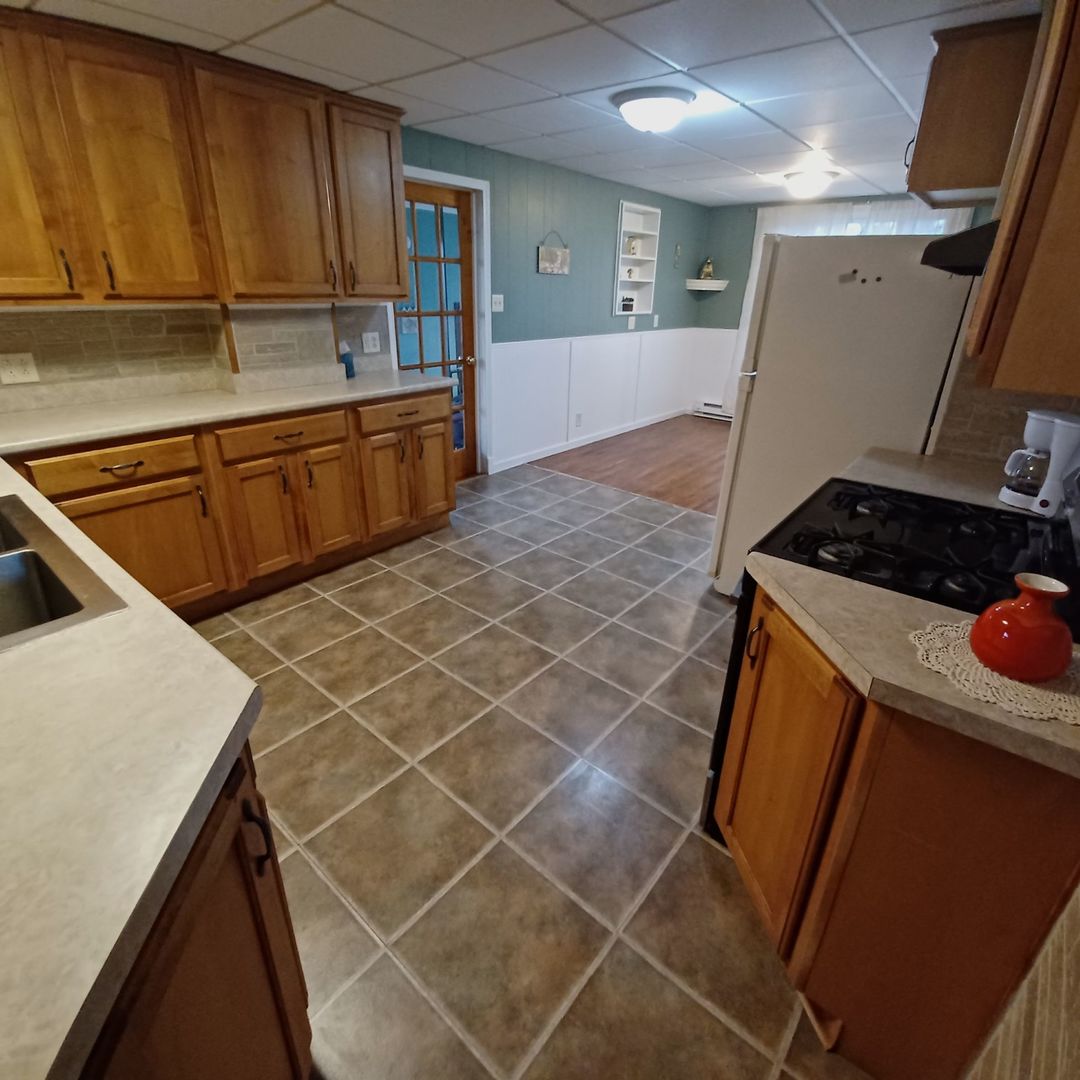 701 East 9th Street Kewanee, IL 61443 - Photo 20 of 56 a kitchen that has a sink and a stove in it