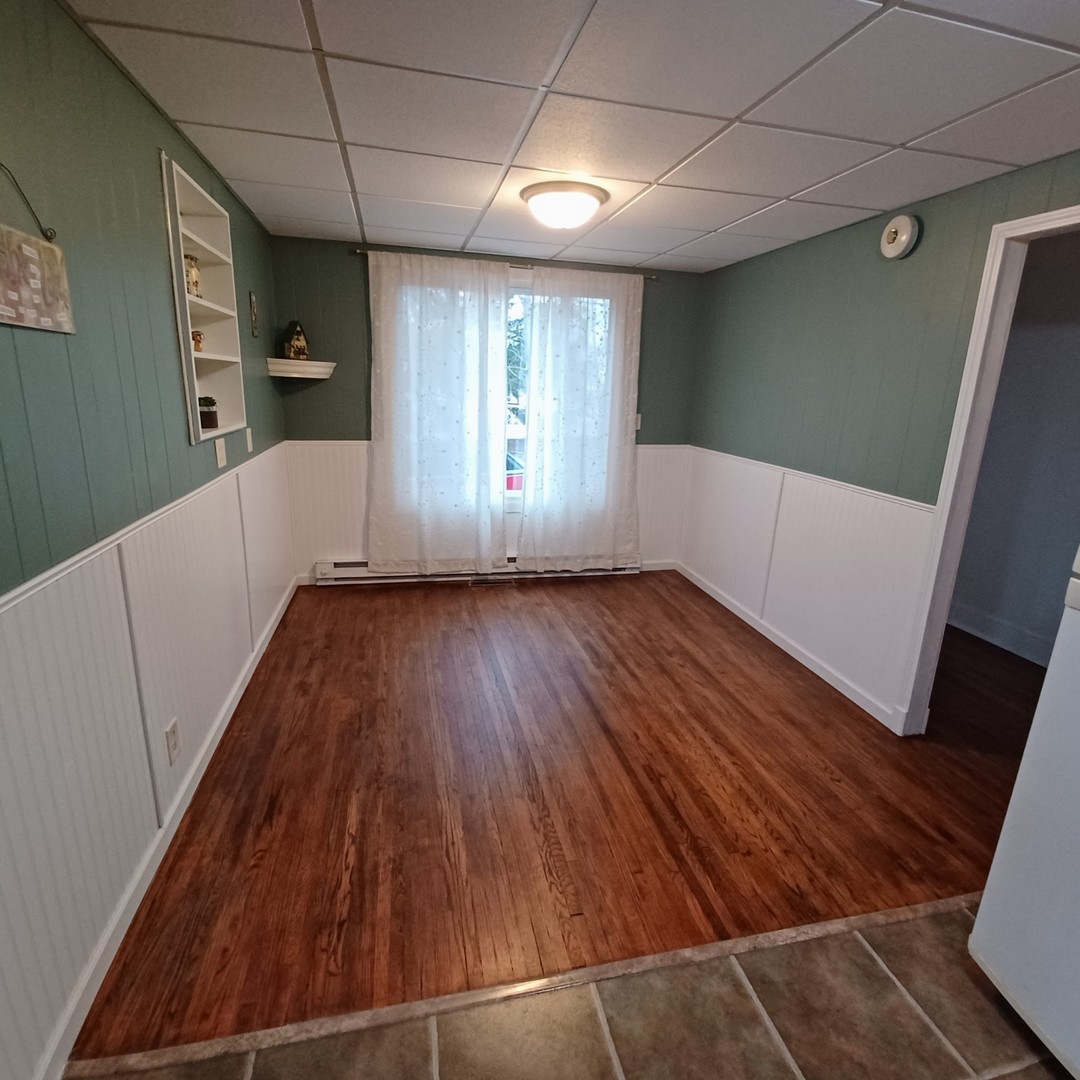 701 East 9th Street Kewanee, IL 61443 - Photo 25 of 56 a view of an empty room with wooden floor and a window