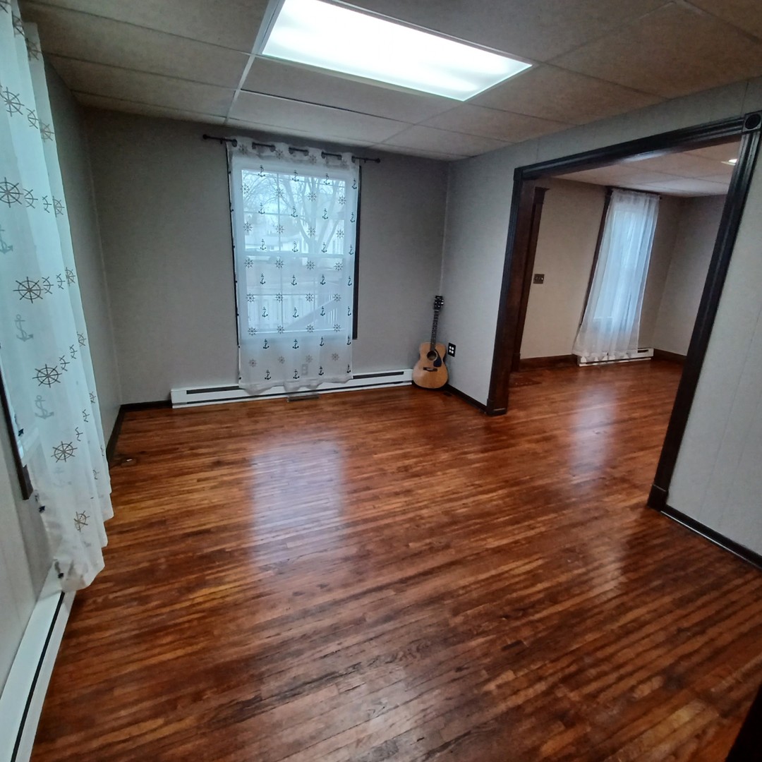 701 East 9th Street Kewanee, IL 61443 - Photo 29 of 56 a view of empty room with wooden floor and fan
