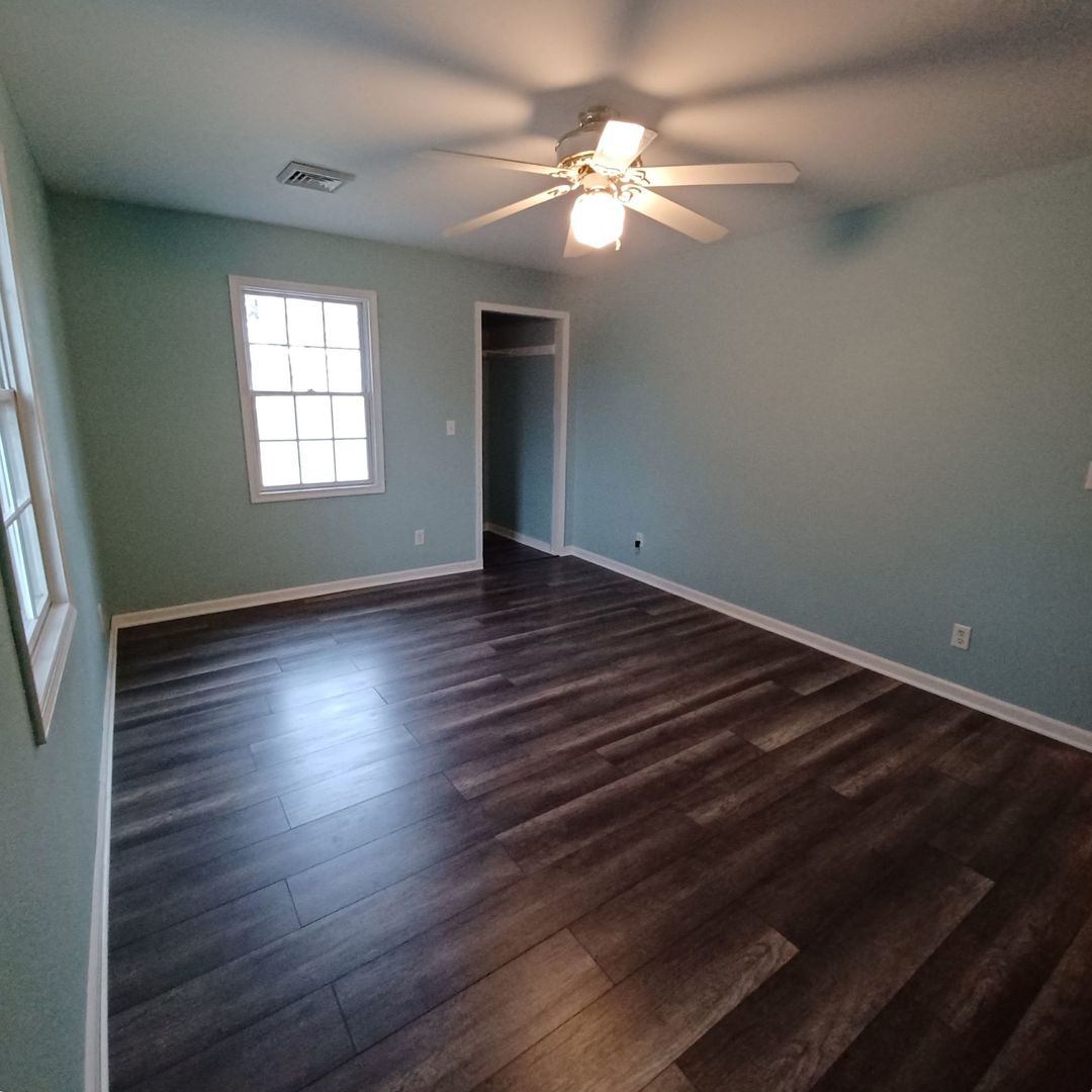 701 East 9th Street Kewanee, IL 61443 - Photo 46 of 56 an empty room with wooden floor chandelier fan and windows