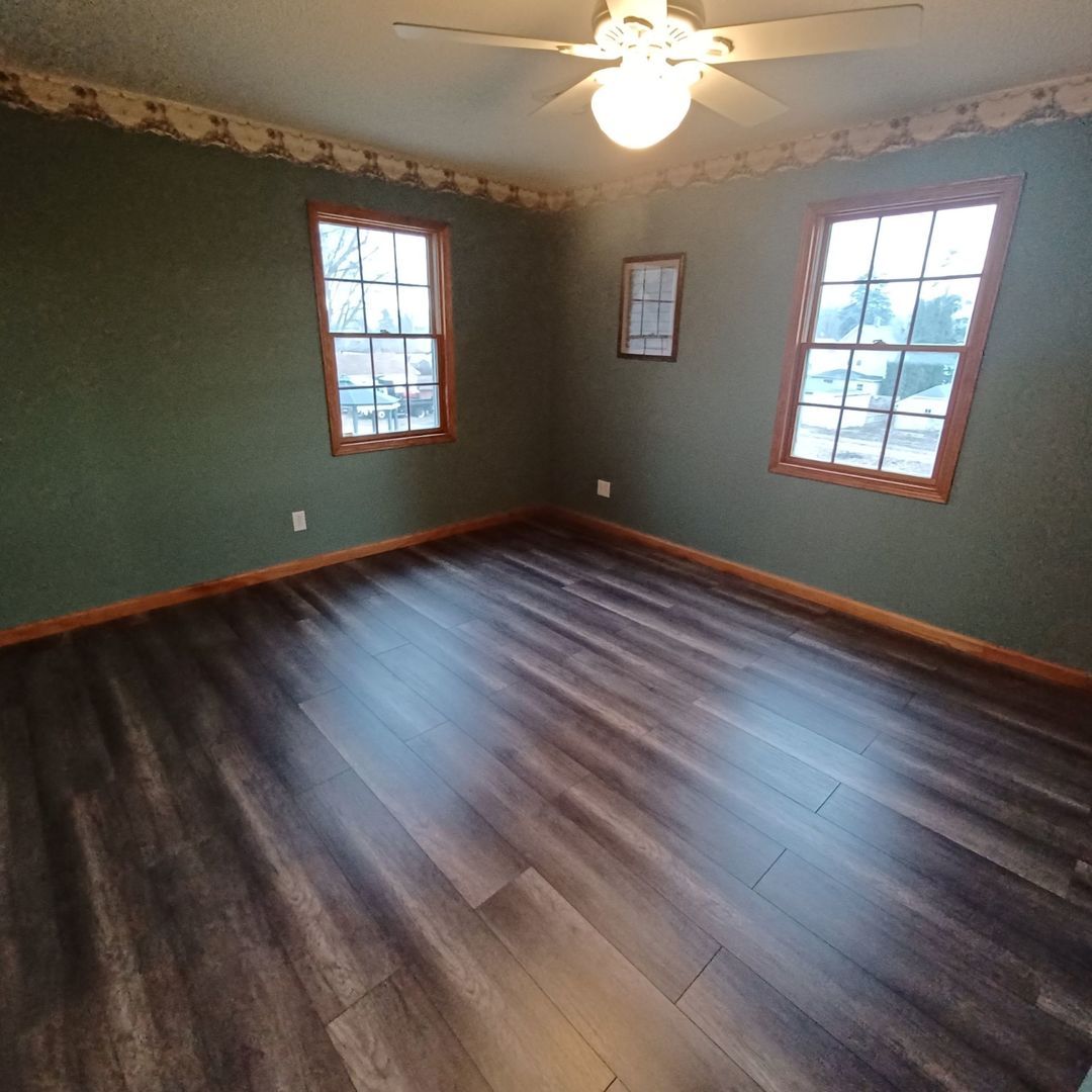 701 East 9th Street Kewanee, IL 61443 - Photo 49 of 56 an empty room with wooden floor and windows
