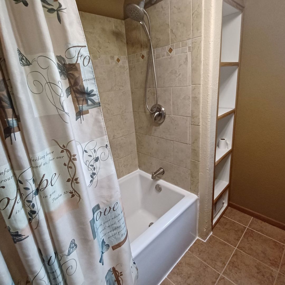 701 East 9th Street Kewanee, IL 61443 - Photo 55 of 56 a bathroom with a bathtub and shower