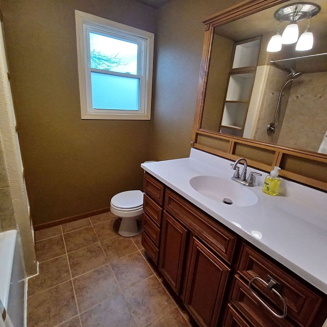 701 East 9th Street Kewanee, IL 61443 - Photo 56 of 56 a bathroom with a sink a toilet a mirror and vanity