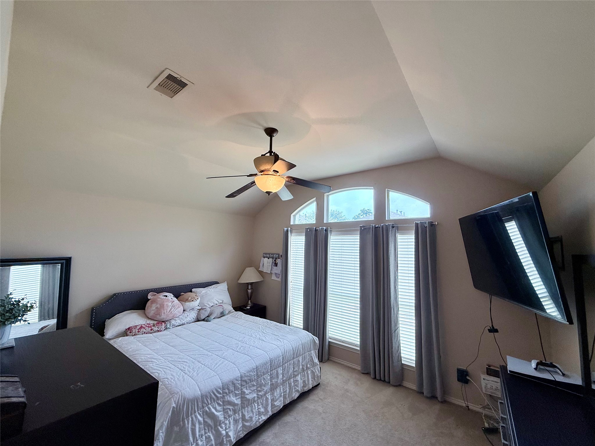2327 Kylie Court Spring, TX 77386 - Photo 7 of 15 a bedroom with a bed a dresser and flat screen tv
