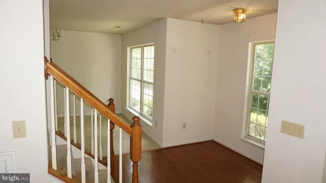a view of an entryway with wooden floor