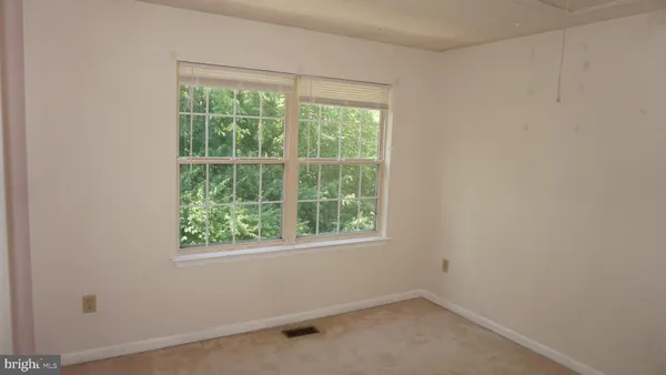 an empty room with closet area