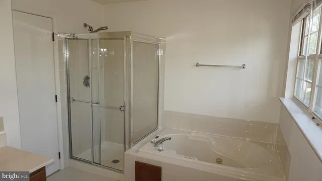 a bathroom with a sink toilet and window
