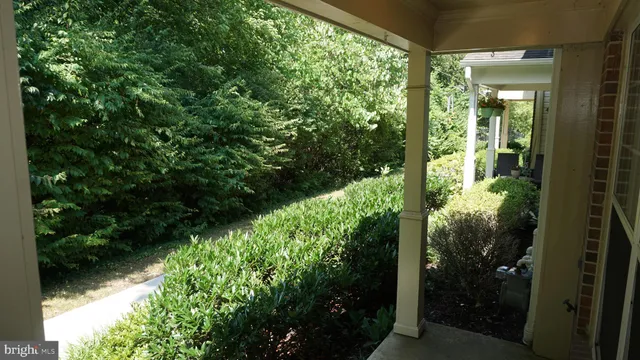 a view of backyard with outdoor seating and car parked