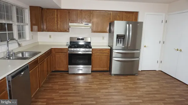 a kitchen with stainless steel appliances a refrigerator stove and sink