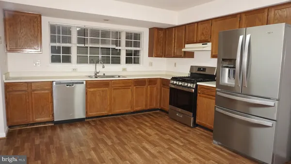 a kitchen with a sink stove and refrigerator