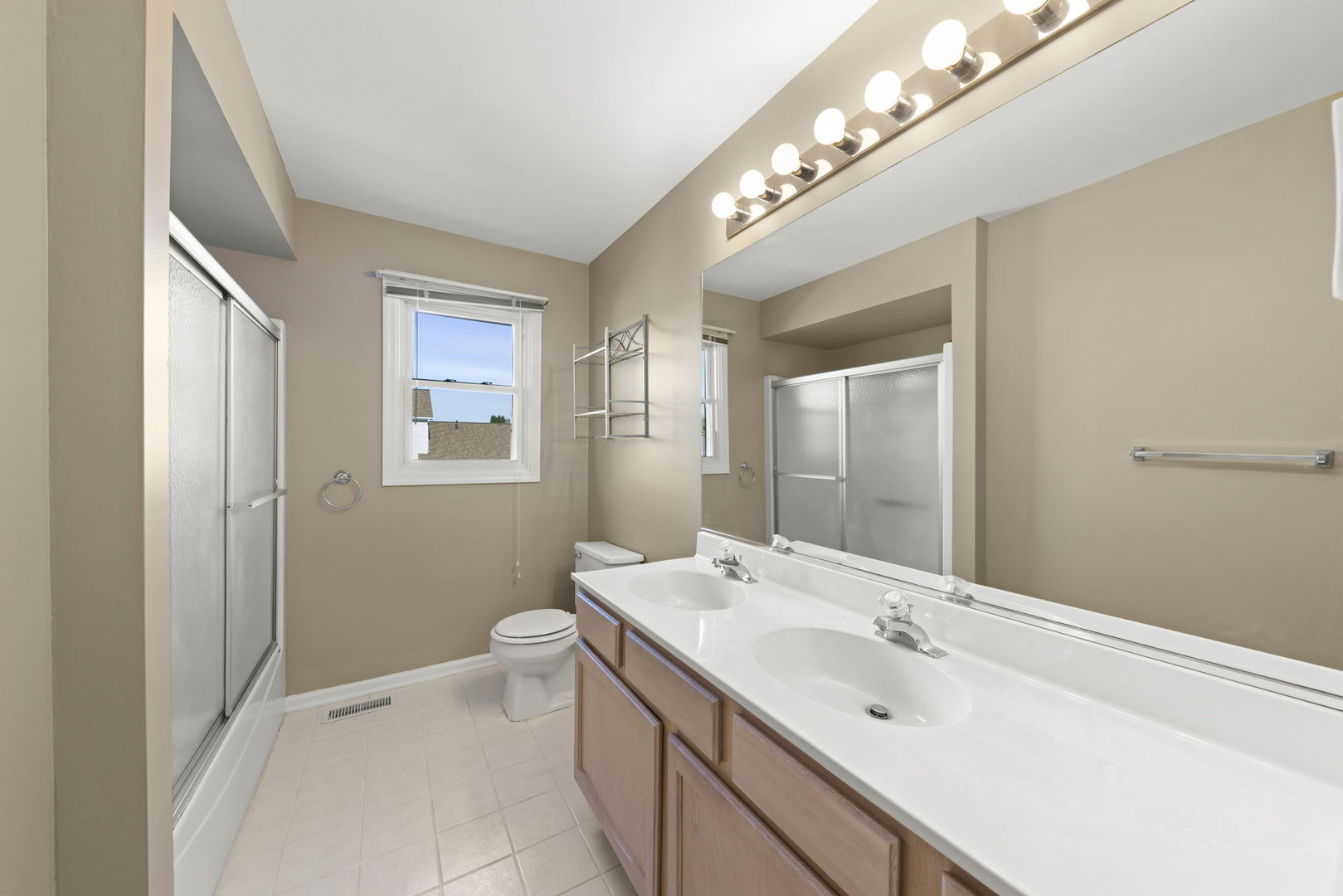 1925 William Drive Crest Hill, IL 60403 - Photo 17 of 32 a bathroom with a double vanity sink and a mirror