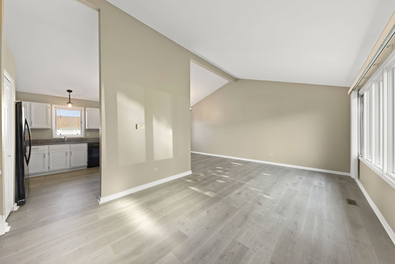 1925 William Drive Crest Hill, IL 60403 - Photo 2 of 32 a view of a hallway with wooden floor and a kitchen