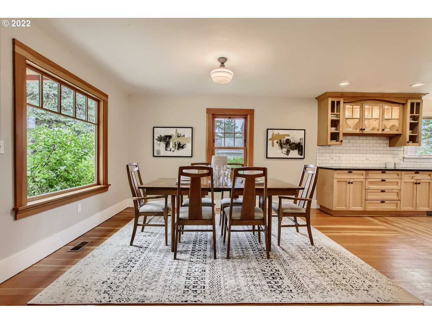 4347 Northeast Sumner Street Portland, OR 97218 - Photo 4 of 25 a view of a dining room with furniture and a floor to ceiling window