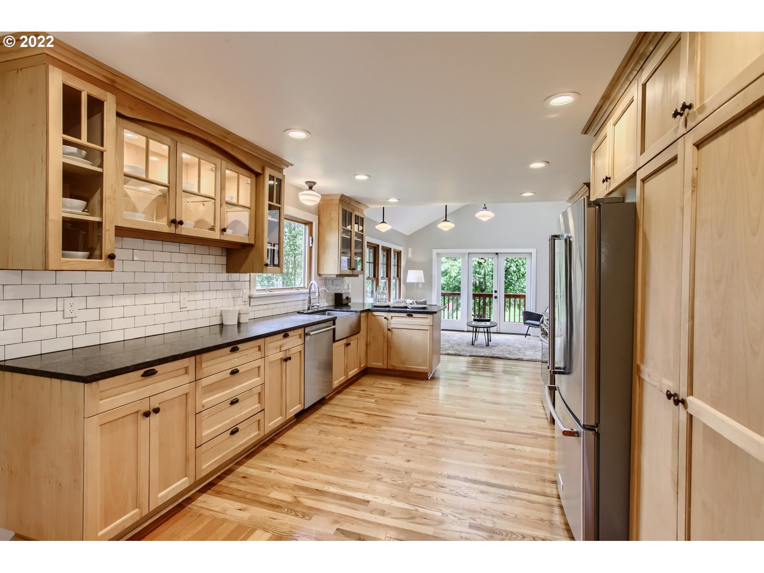 4347 Northeast Sumner Street Portland, OR 97218 - Photo 6 of 25 a large kitchen with stainless steel appliances kitchen island granite countertop a refrigerator and a stove
