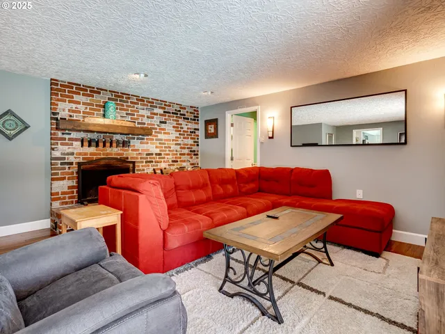 a living room with furniture a rug and a window