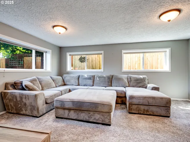 a living room with couches and a large window