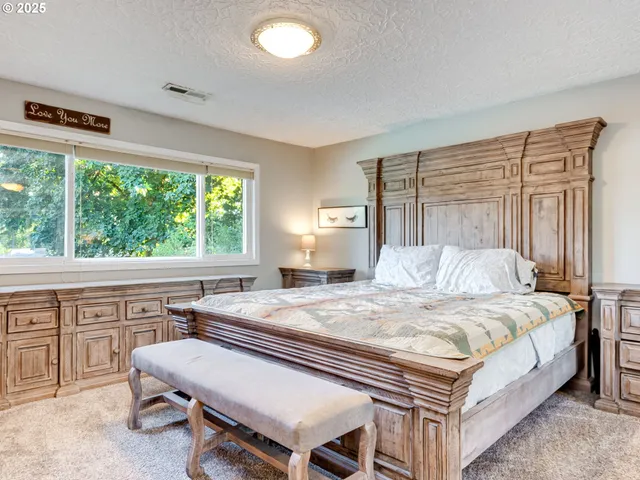 a bedroom with a bed and a table in it