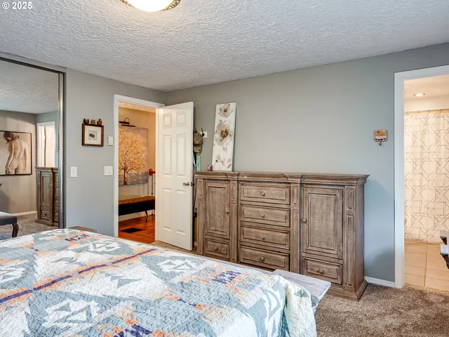 a bedroom with a bed and a mirror