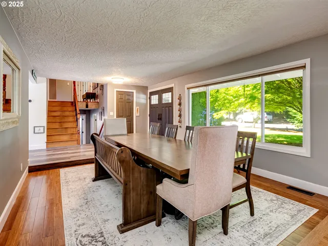 a dining room with furniture and wooden floor