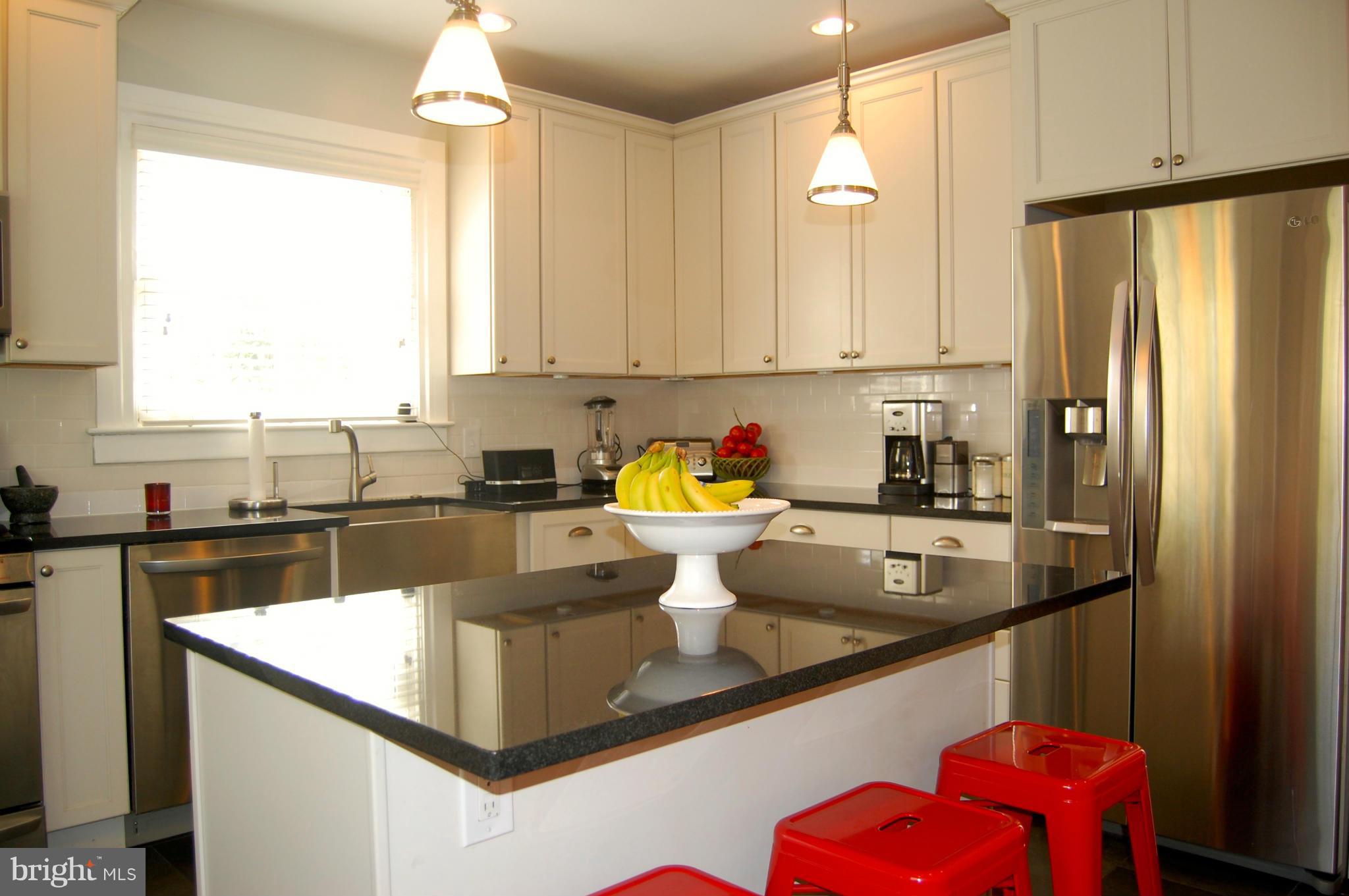 345 Tunbridge Road Baltimore, MD 21212 - Photo 12 of 30 a kitchen with a refrigerator a stove a sink and a window