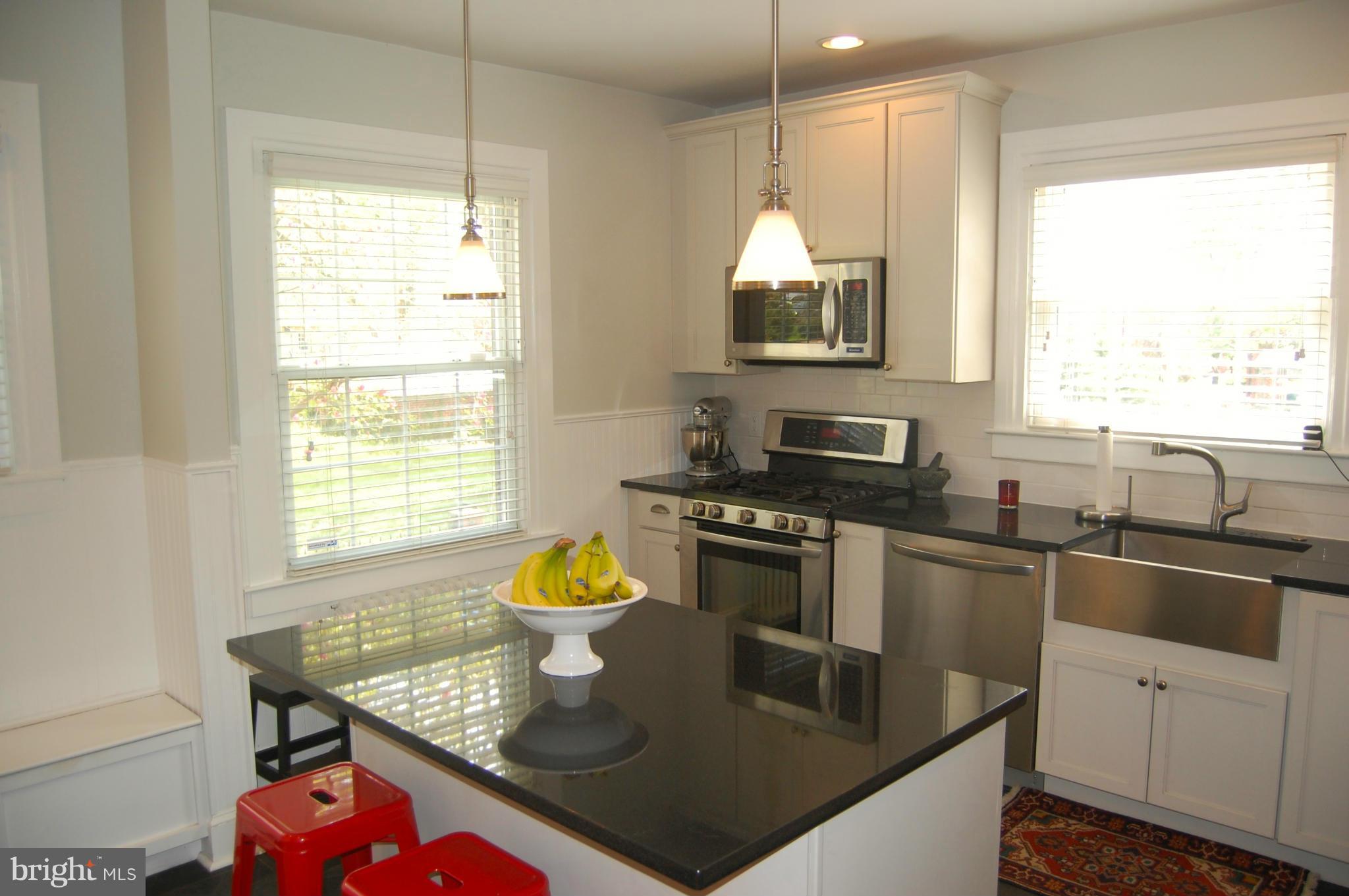 345 Tunbridge Road Baltimore, MD 21212 - Photo 13 of 30 a kitchen with stainless steel appliances granite countertop a sink a stove and a microwave